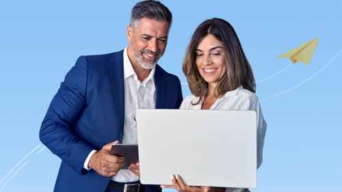 An image featuring smiling man and woman looking at a monitor